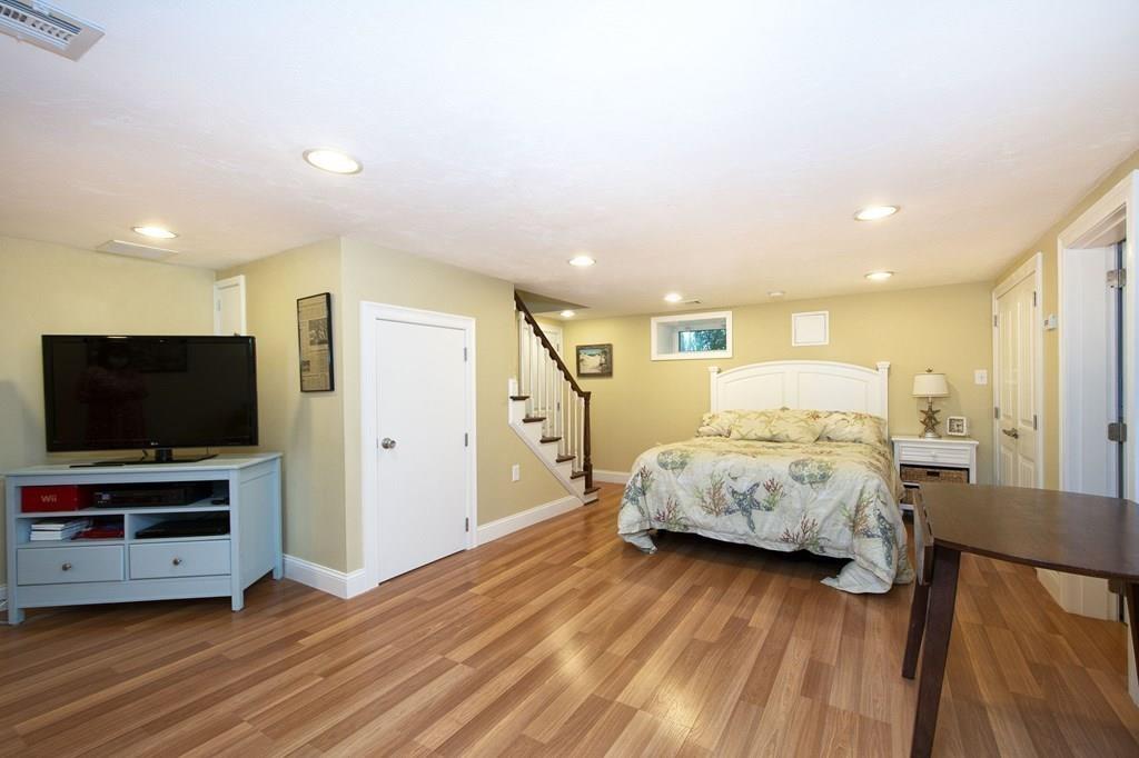 37 Damon Road Scituate, MA 02066 - Photo 30 of 39 a spacious bedroom with a bed and a flat screen tv