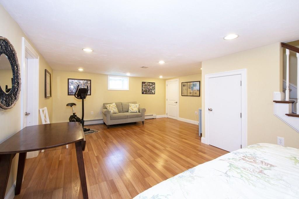 37 Damon Road Scituate, MA 02066 - Photo 31 of 39 a spacious bedroom with a bed and wooden floor