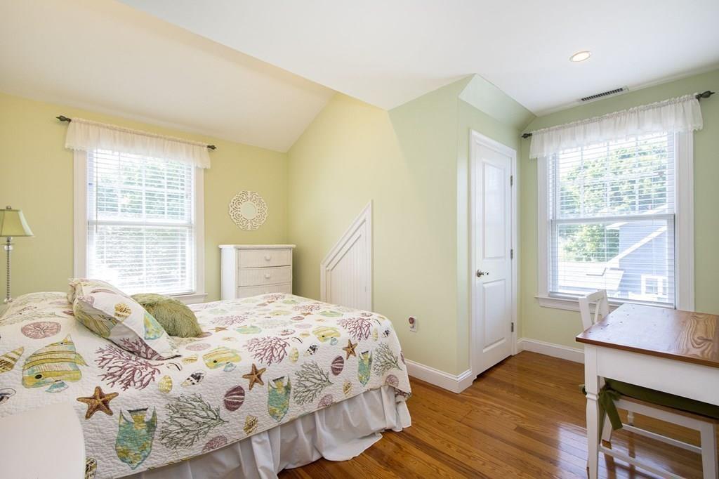 37 Damon Road Scituate, MA 02066 - Photo 33 of 39 a bedroom with a bed and a table in it with wooden floor