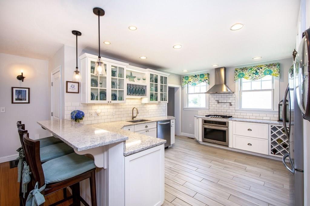 37 Damon Road Scituate, MA 02066 - Photo 6 of 39 a kitchen with a stove a sink dishwasher and a stove with wooden floor