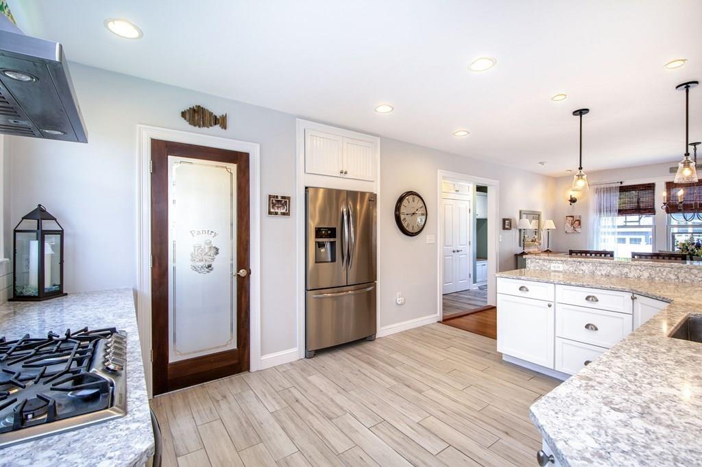 37 Damon Road Scituate, MA 02066 - Photo 7 of 39 a kitchen with stainless steel appliances granite countertop a refrigerator and a stove top oven