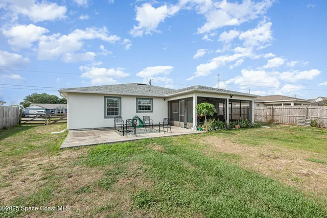 a front view of a house with swimming pool having outdoor seating