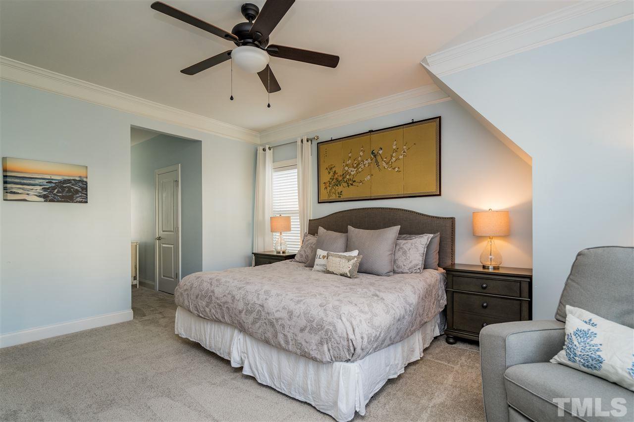 1528 Rodessa Run Raleigh, NC 27607 - Photo 21 of 30 Owner's Suite features new carpet, two closets with wooden shelving and en suite bathroom.