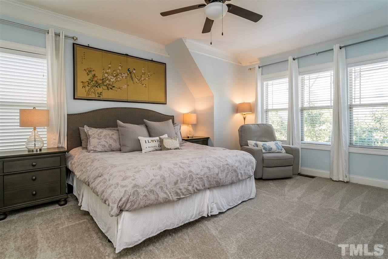1528 Rodessa Run Raleigh, NC 27607 - Photo 22 of 30 Owner's Suite features new carpet, two closets with wooden shelving and en suite bathroom.