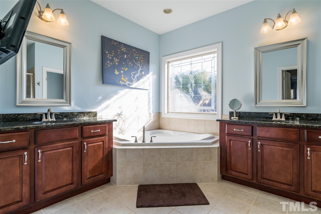 1528 Rodessa Run Raleigh, NC 27607 - Photo 23 of 30 Ceramic tile, two separate sinks, granite counters, garden tub, separate shower, separate water closet.