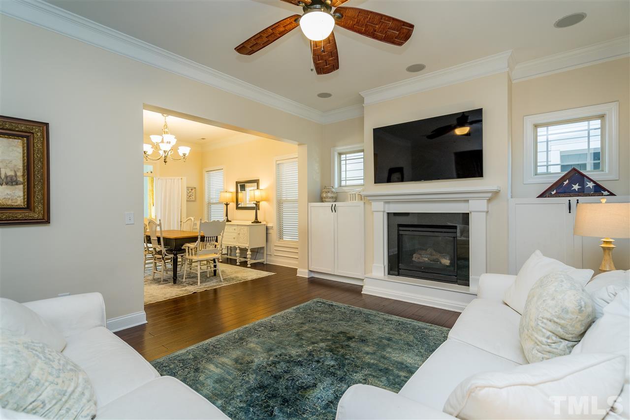 1528 Rodessa Run Raleigh, NC 27607 - Photo 9 of 30 Natural gas fireplace, custom cabinets, hardwoods, 10' ceilings and two piece crown molding.