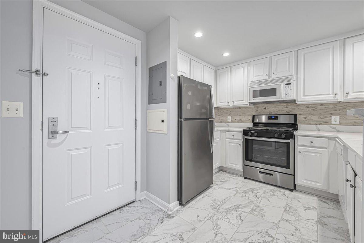 a kitchen with cabinets and stainless steel appliances