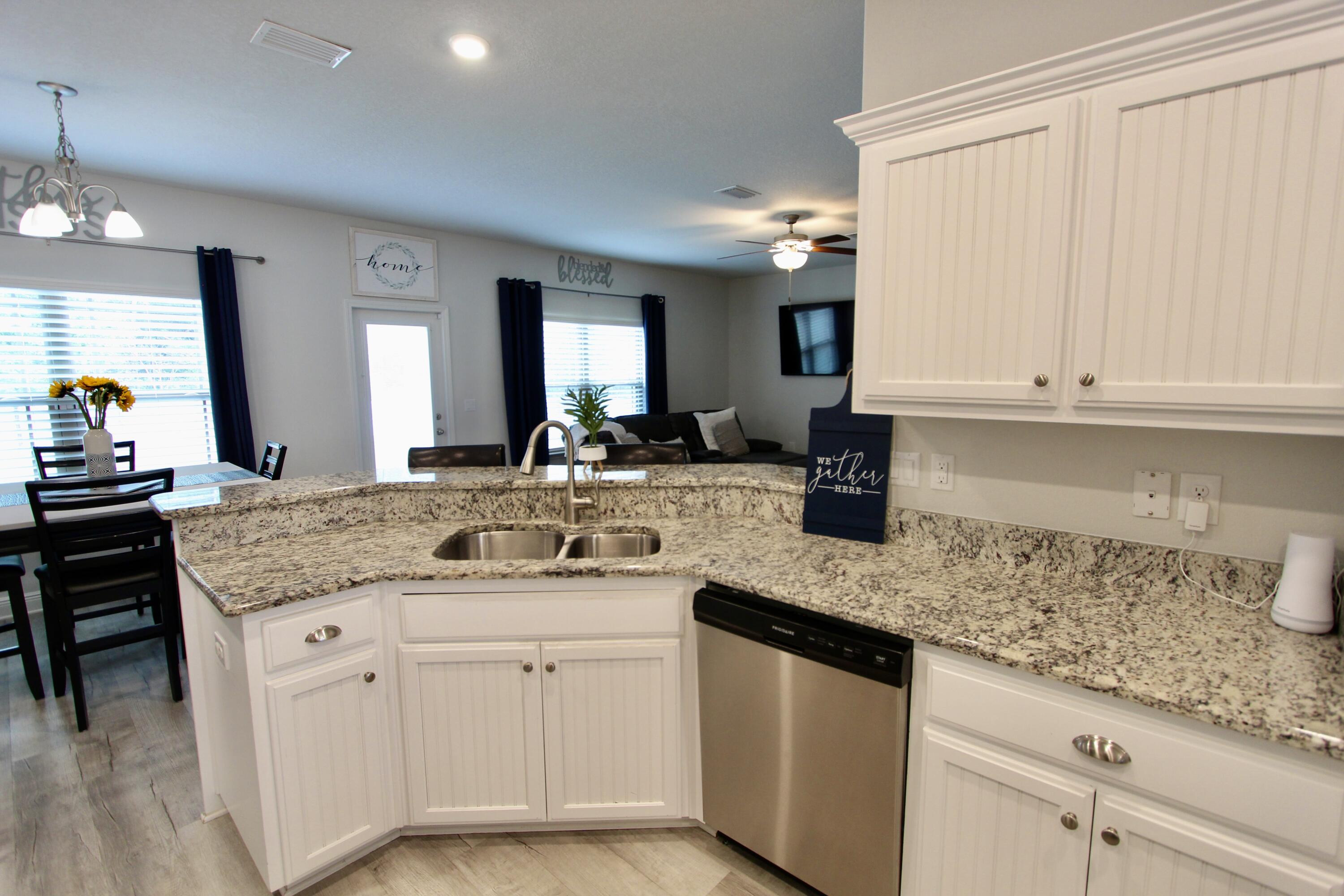 5755 Marigold Loop Crestview, FL 32539 - Photo 22 of 74 a kitchen with stainless steel appliances granite countertop a sink and cabinets