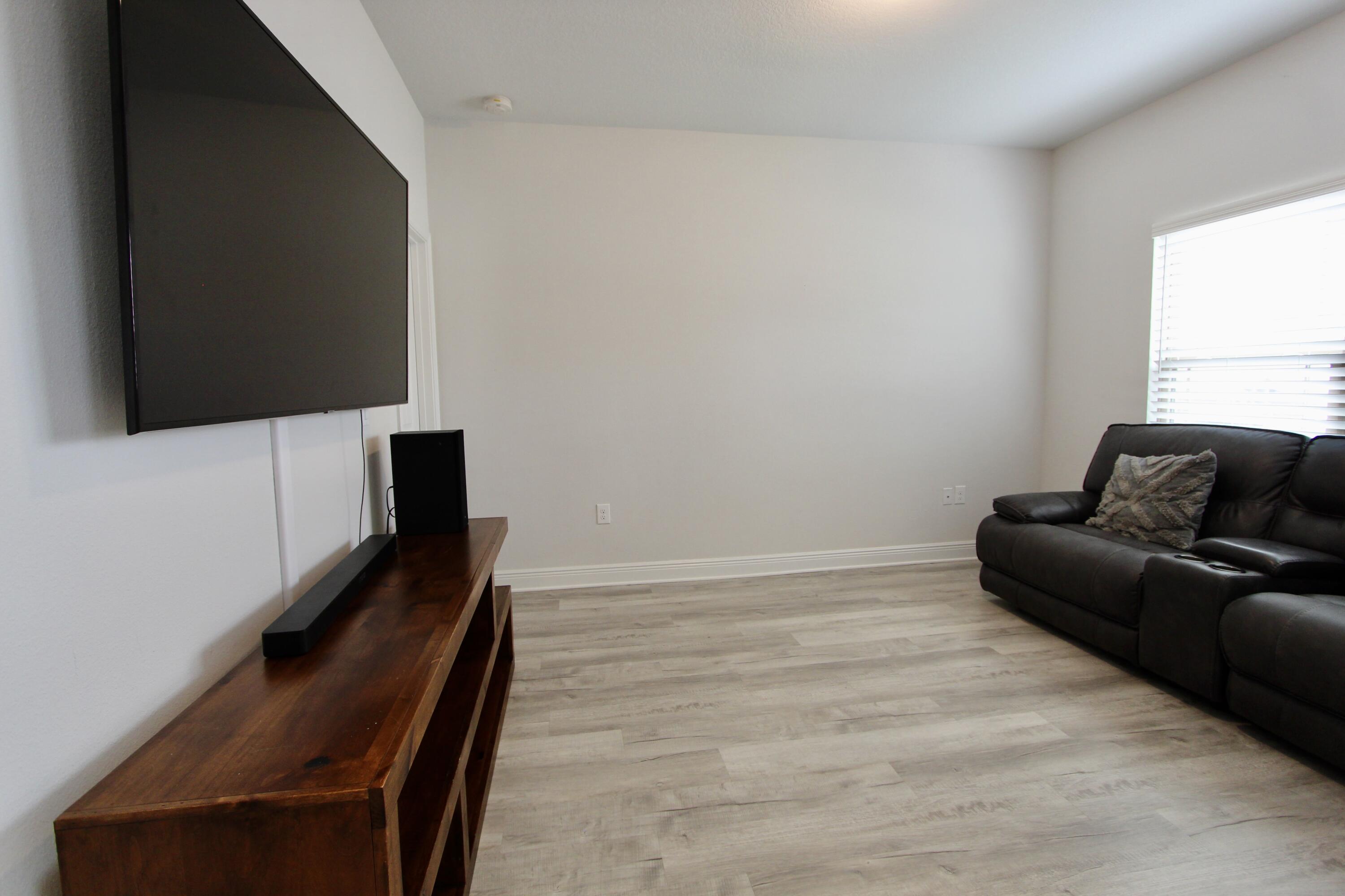 5755 Marigold Loop Crestview, FL 32539 - Photo 26 of 74 a living room with furniture and a flat screen tv