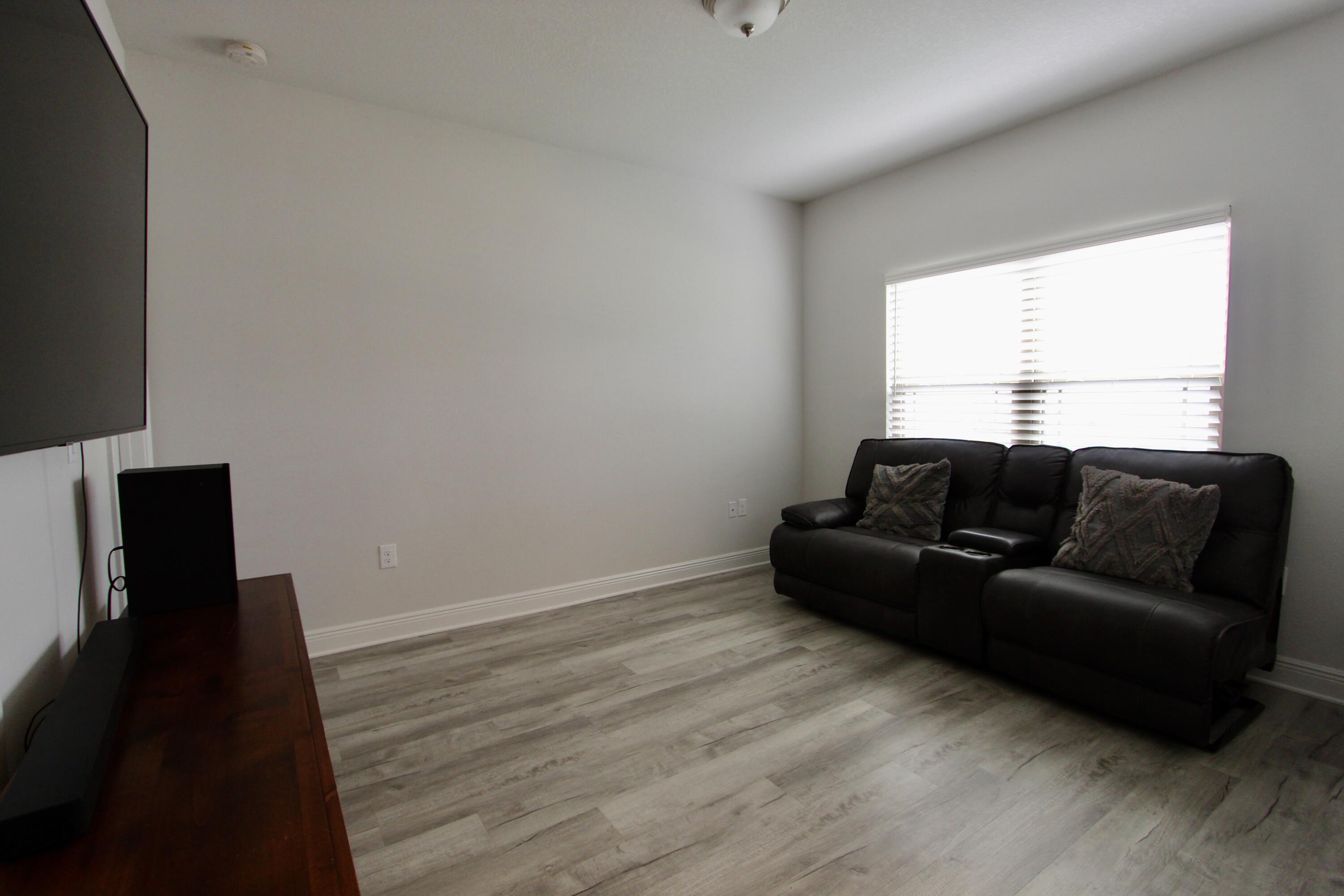 5755 Marigold Loop Crestview, FL 32539 - Photo 27 of 74 a living room with a couch and a flat screen tv