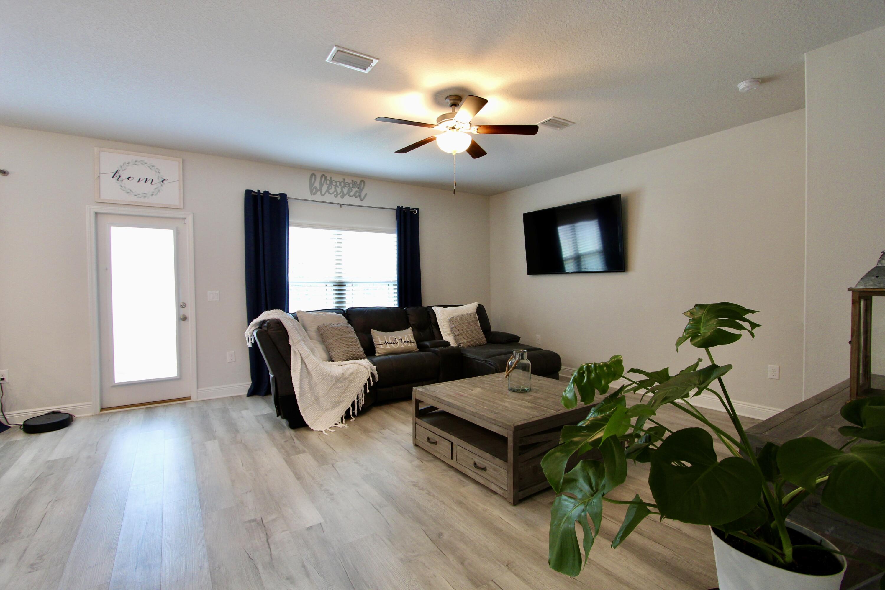 5755 Marigold Loop Crestview, FL 32539 - Photo 40 of 74 a living room with furniture potted plant and a window