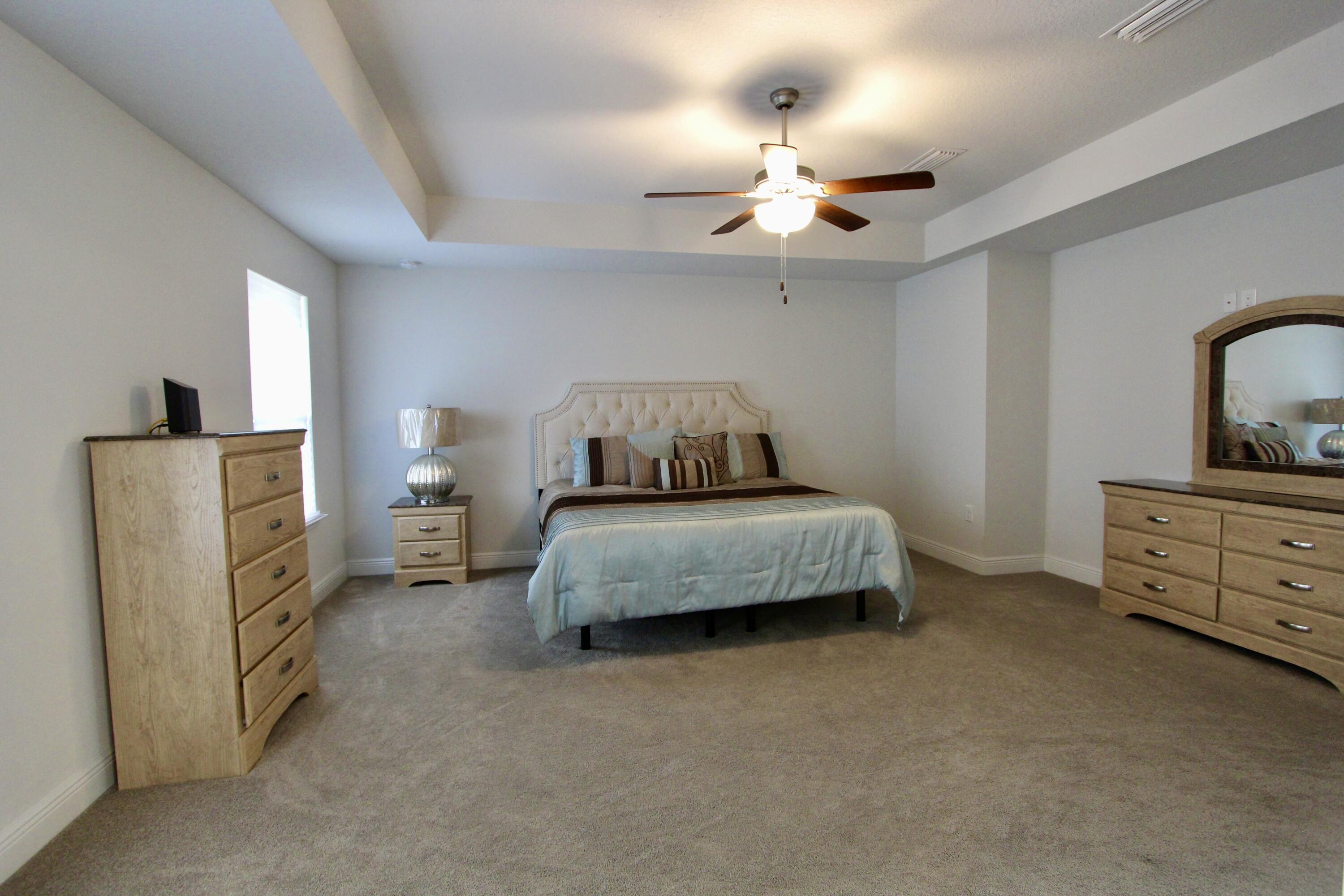 5755 Marigold Loop Crestview, FL 32539 - Photo 50 of 74 a bedroom with a bed and ceiling fan