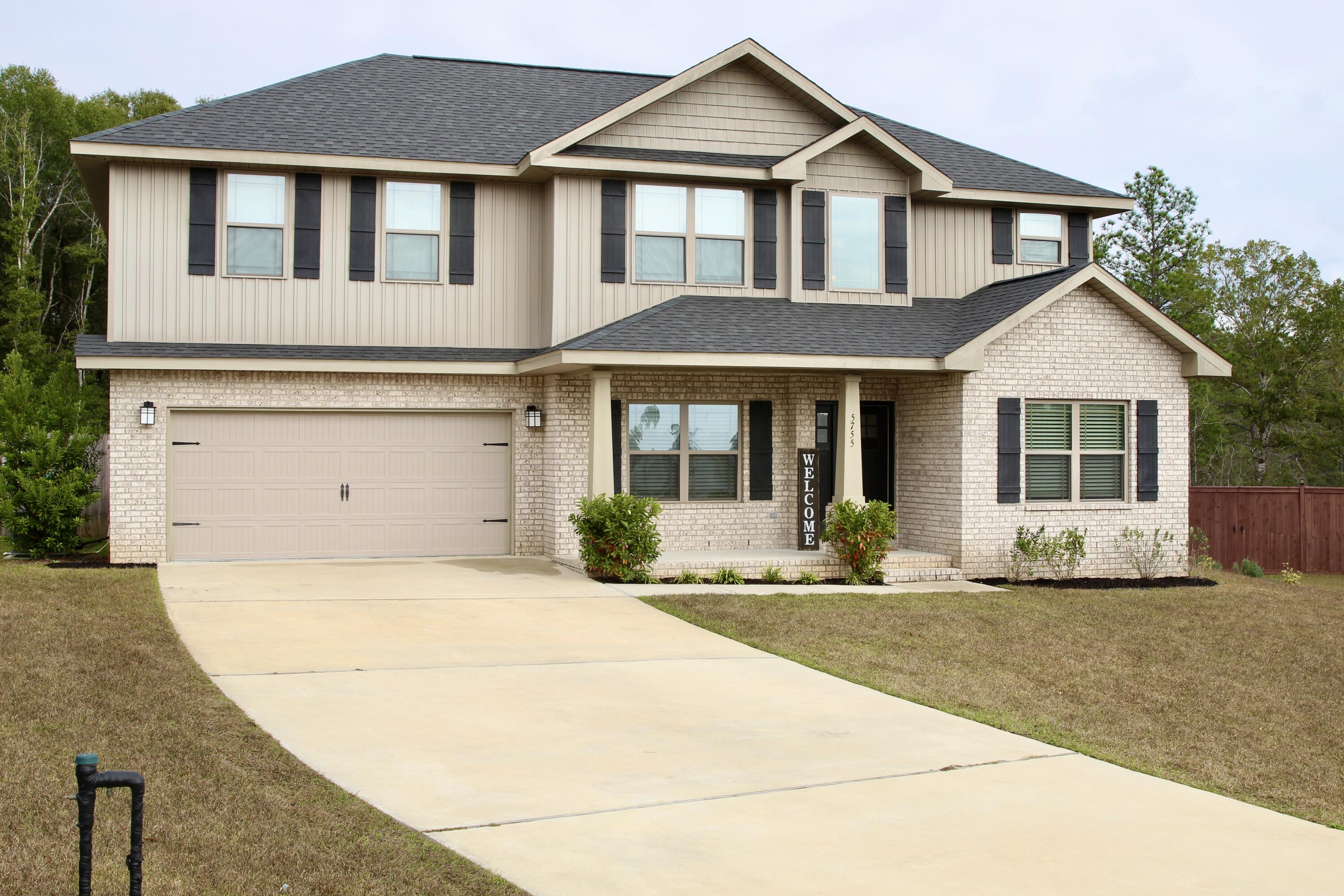 5755 Marigold Loop Crestview, FL 32539 - Photo 5 of 74 a front view of a house with a yard