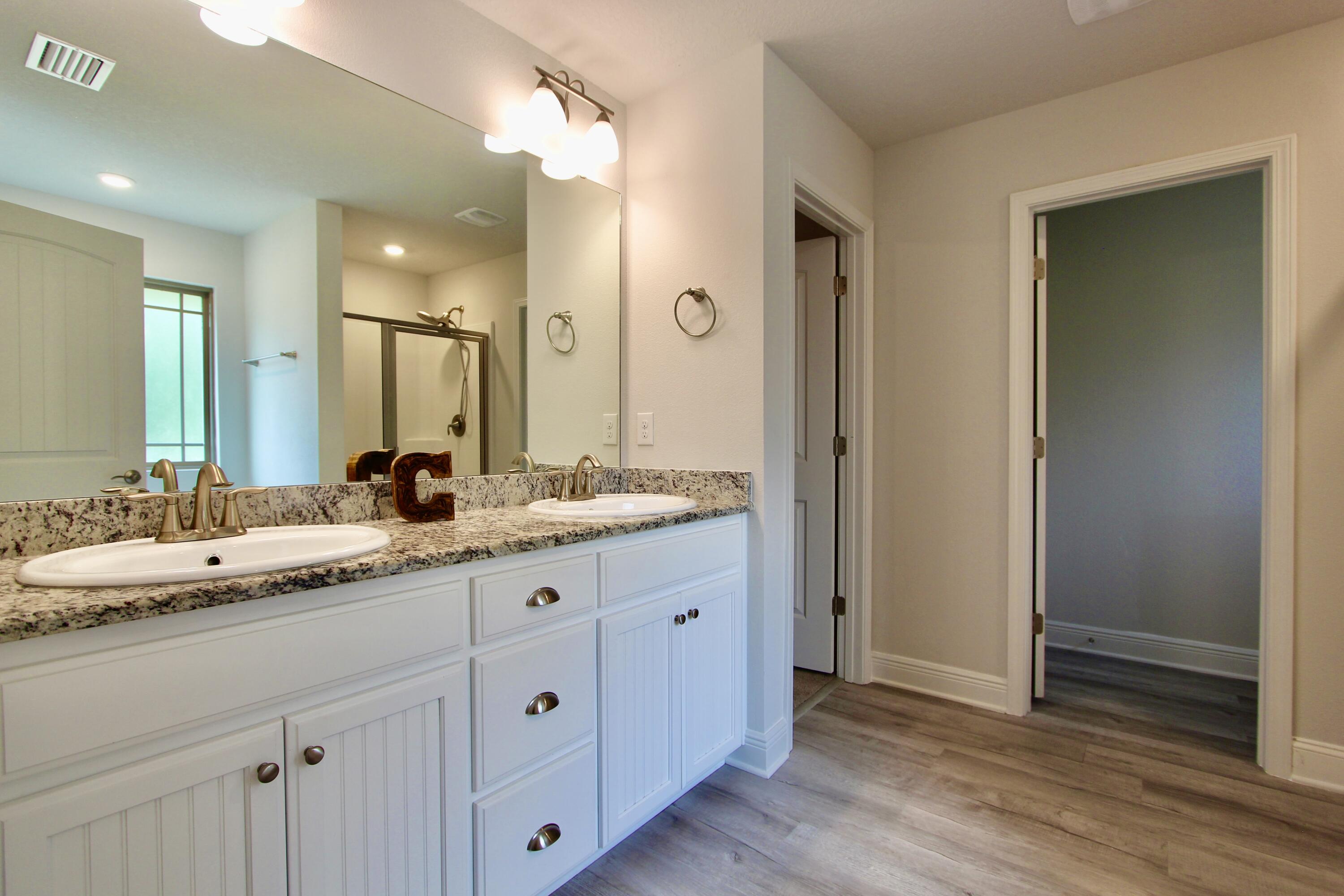 5755 Marigold Loop Crestview, FL 32539 - Photo 51 of 74 a bathroom with a granite countertop double vanity sink and mirror