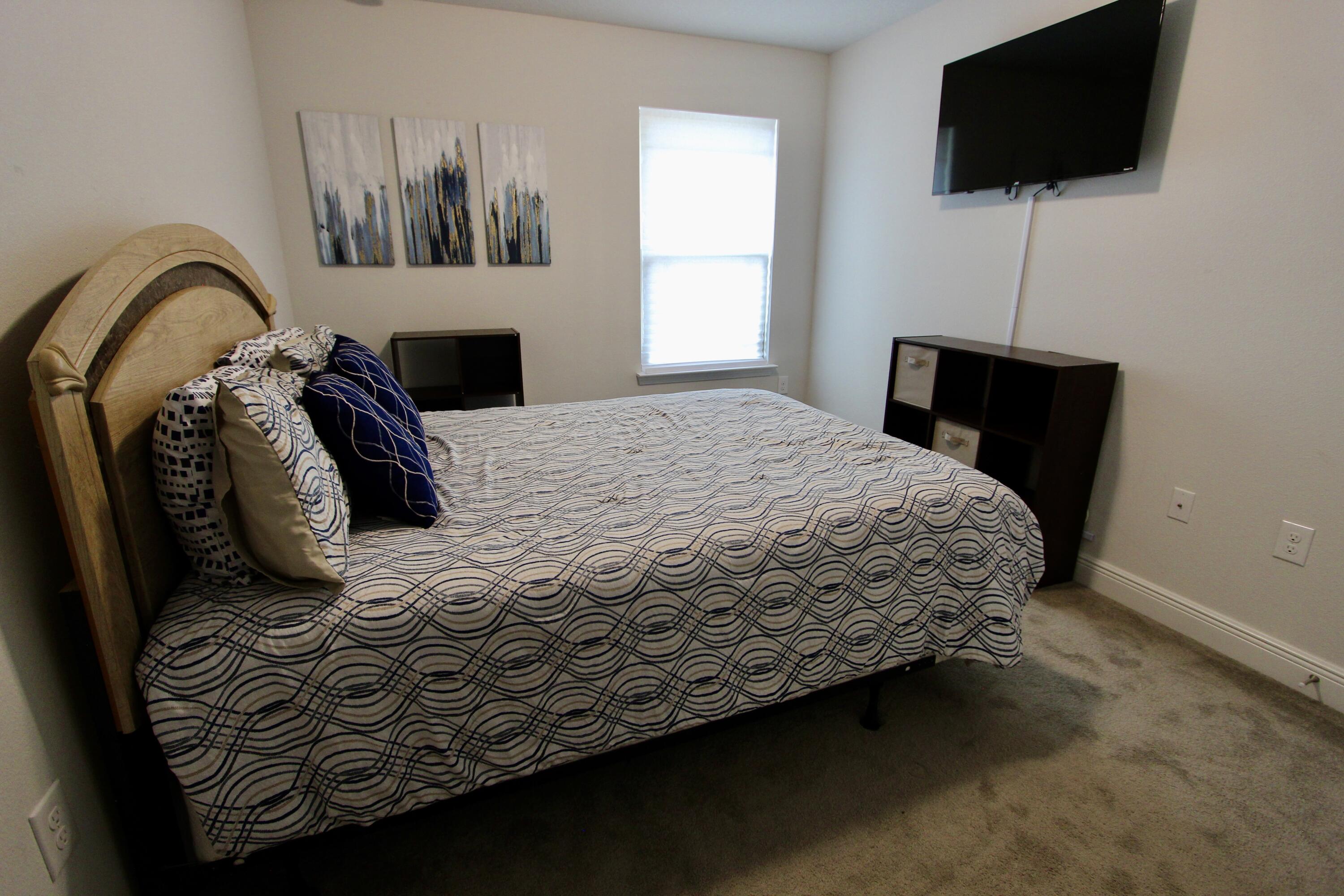 5755 Marigold Loop Crestview, FL 32539 - Photo 66 of 74 a bedroom with a bed a flat screen tv and a window