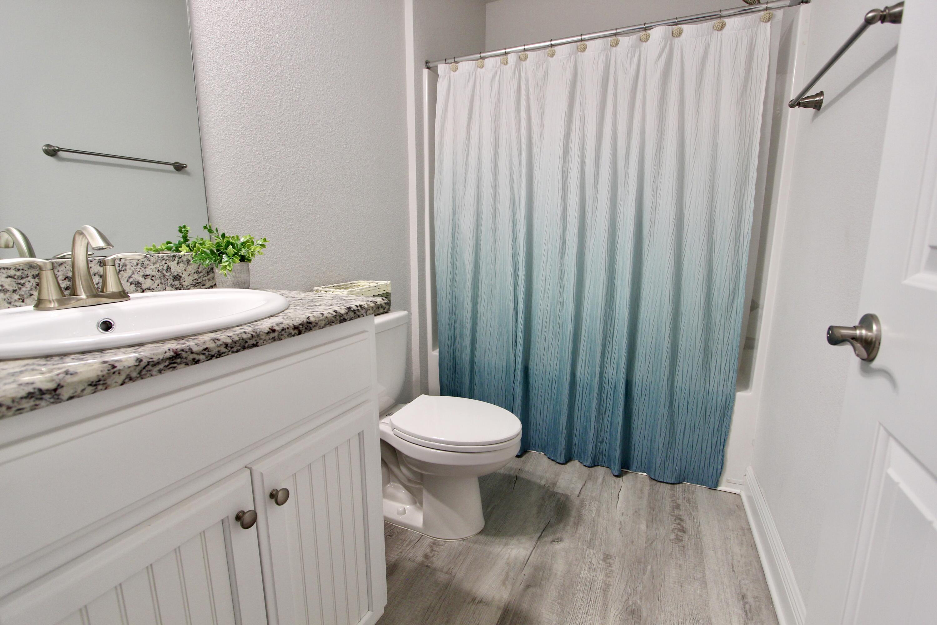 5755 Marigold Loop Crestview, FL 32539 - Photo 67 of 74 a bathroom with a granite countertop sink toilet and shower