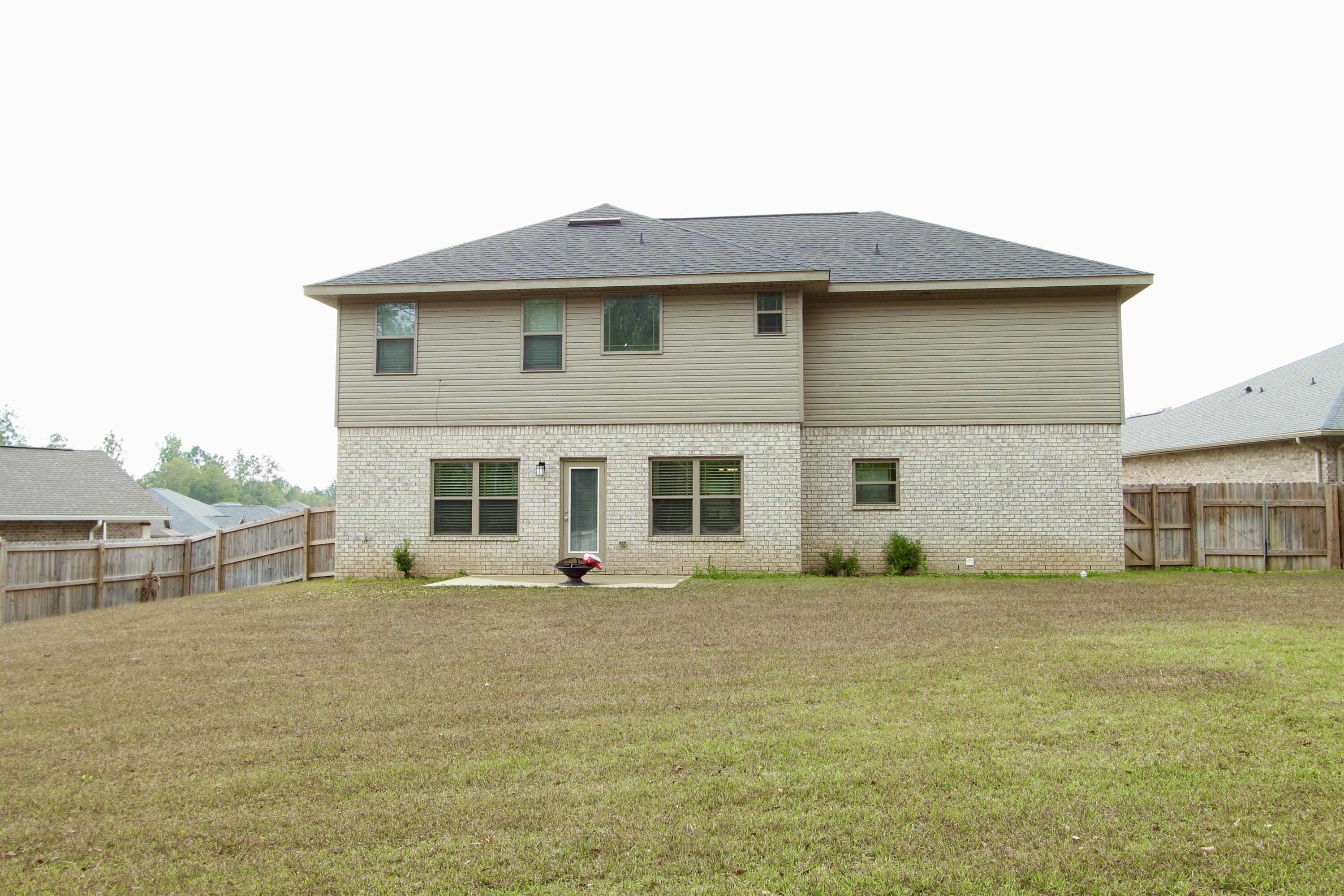 5755 Marigold Loop Crestview, FL 32539 - Photo 70 of 74 a front view of a house with a yard