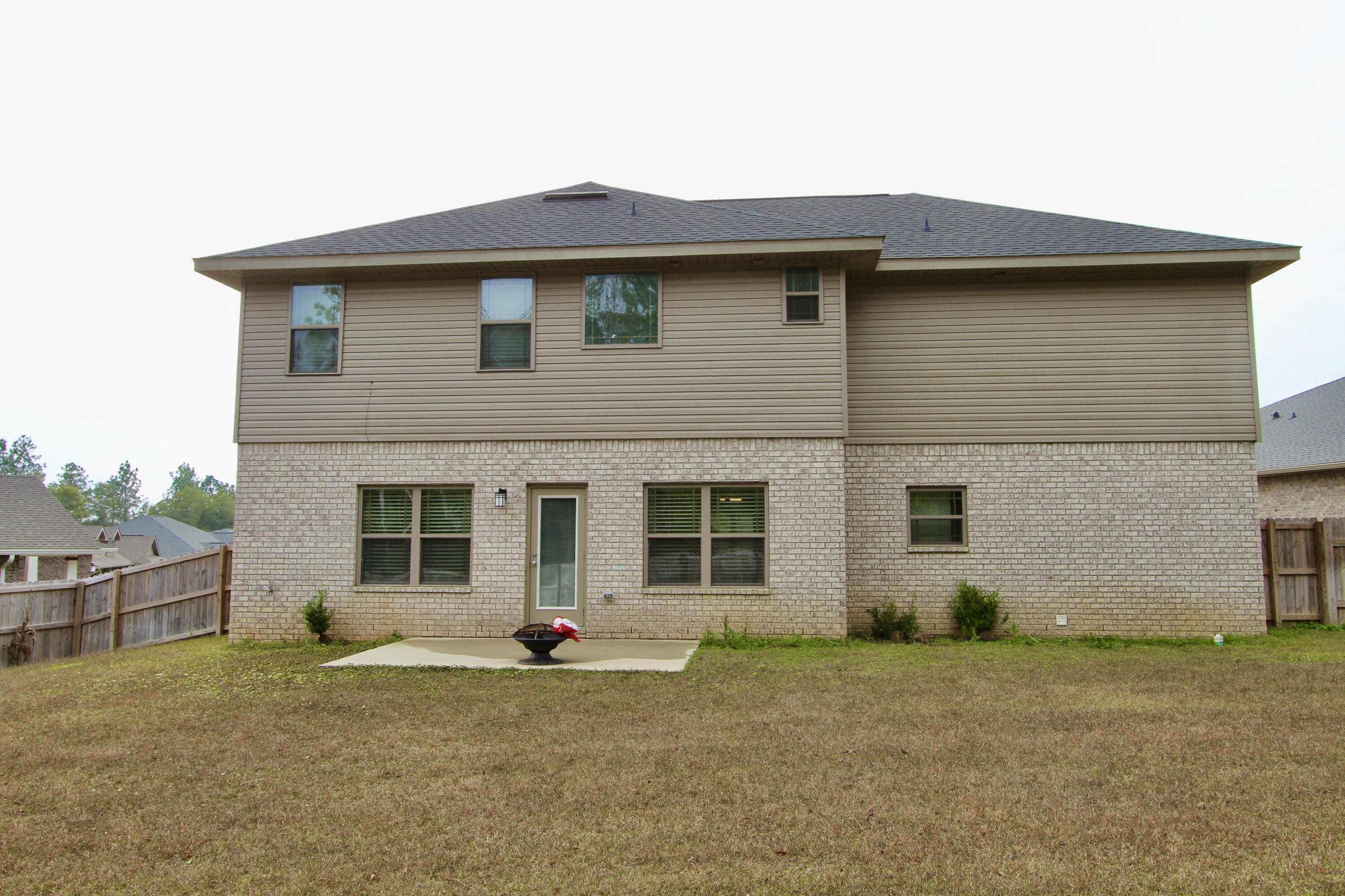 5755 Marigold Loop Crestview, FL 32539 - Photo 71 of 74 a front view of a house with a garden