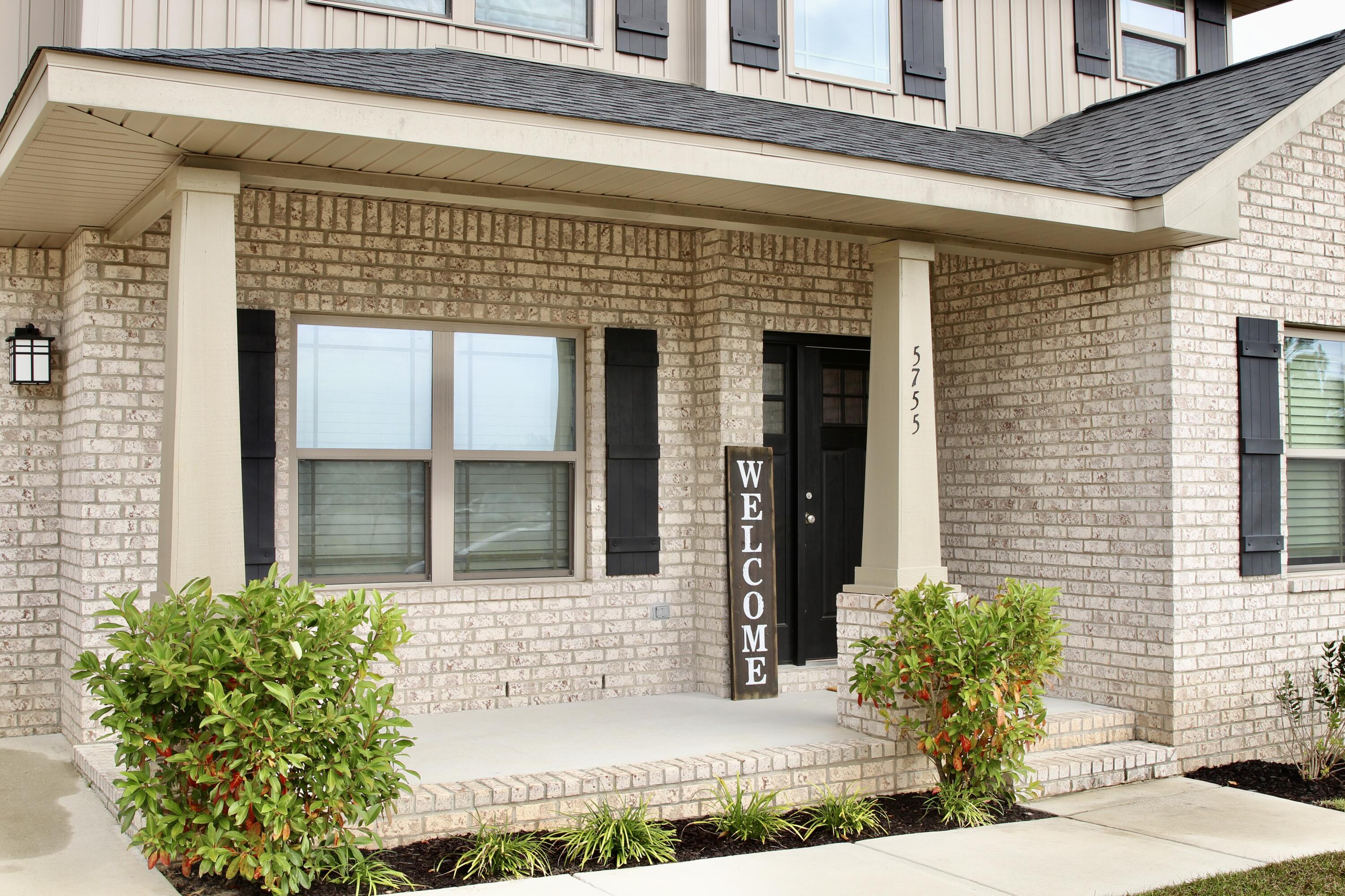 5755 Marigold Loop Crestview, FL 32539 - Photo 8 of 74 a front view of a house with garden