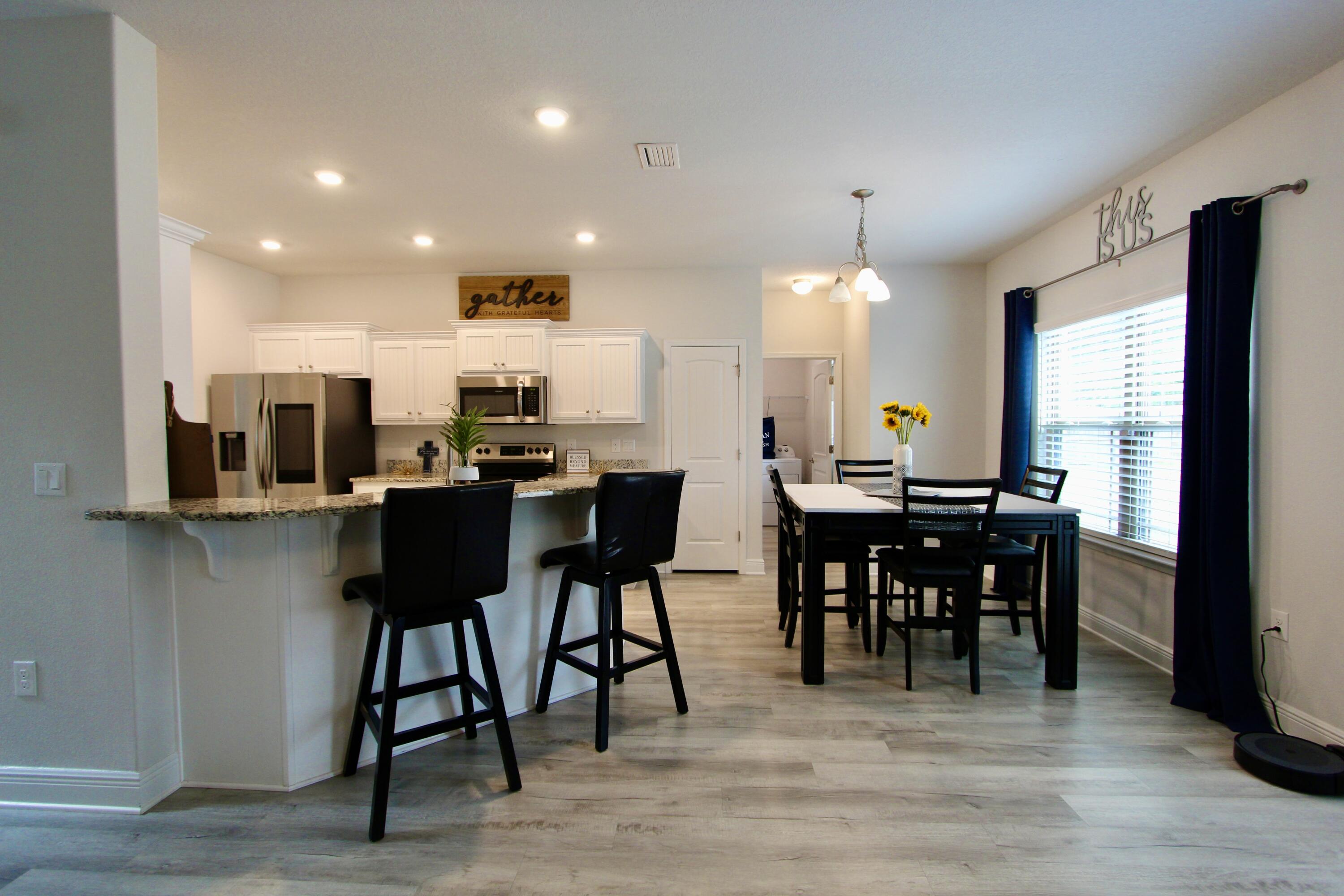 5755 Marigold Loop Crestview, FL 32539 - Photo 9 of 74 a view of a a dining room with furniture window and wooden floor