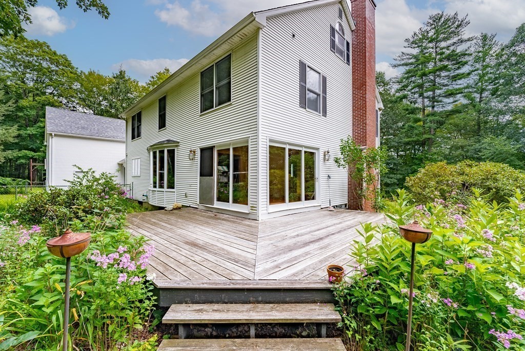 218 N Road Westhampton, MA 01027 - Photo 38 of 42 a view of a house with potted plants and a fountain