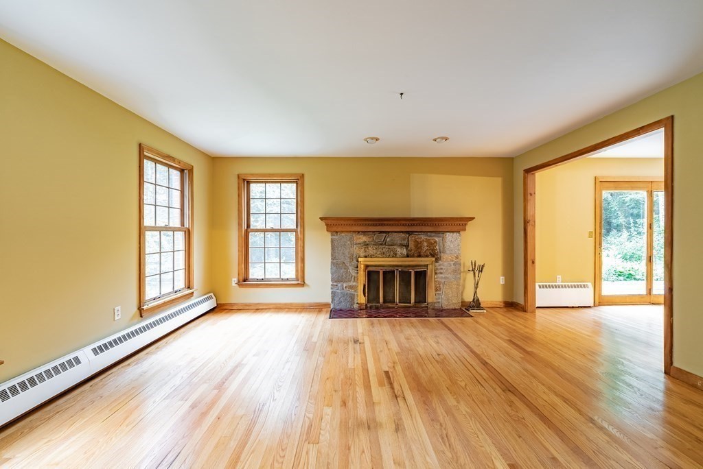 218 N Road Westhampton, MA 01027 - Photo 4 of 42 a view of empty room with wooden floor and fireplace