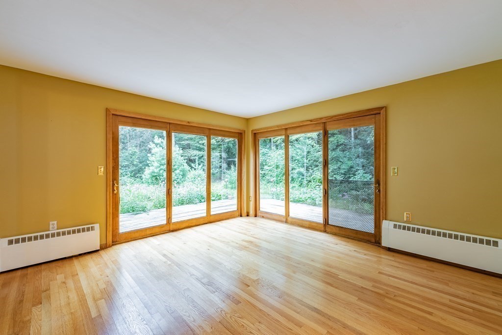218 N Road Westhampton, MA 01027 - Photo 8 of 42 a view of an empty room with wooden floor and a window