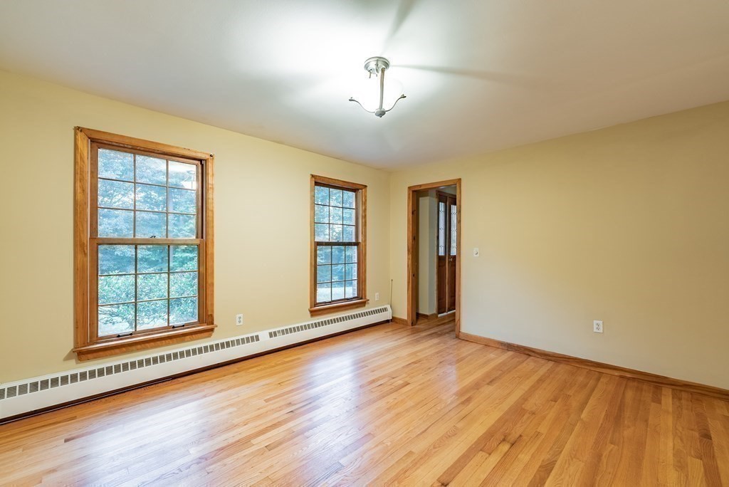 218 N Road Westhampton, MA 01027 - Photo 10 of 42 an empty room with wooden floor and windows