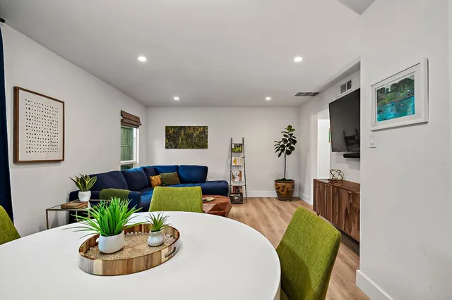 a living room with kitchen island furniture and a chandelier