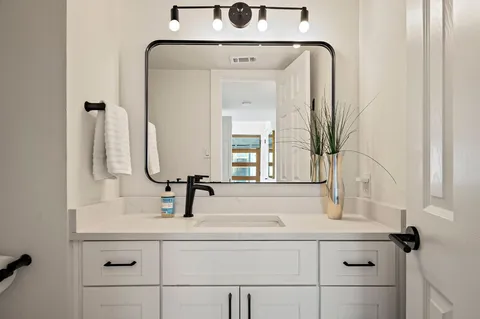 a bathroom with a sink and a mirror