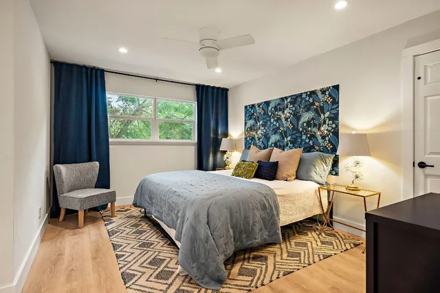 a bedroom with a bed and wooden floor