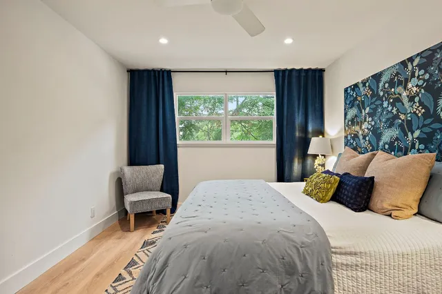 a bedroom with a bed and a window