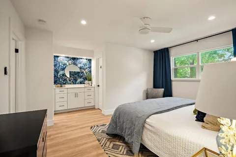 a bedroom with a large bed and a chandelier