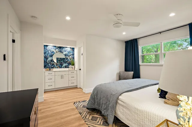 a bedroom with a large bed and a chandelier