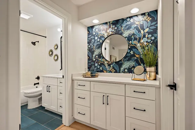 a bathroom with a toilet a sink and mirror