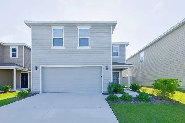 a front view of a house with a yard and garage