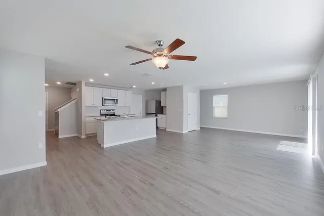 a view of a kitchen with a sink and a stove top oven