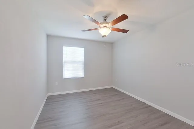 wooden floor in an empty room with a window
