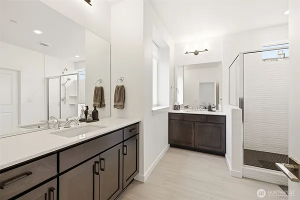 a bathroom with a double vanity sink mirror and double