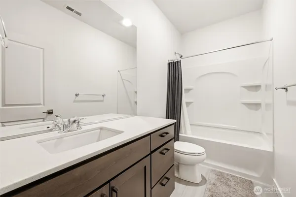 a bathroom with a sink toilet tub and shower