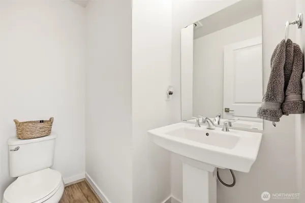a bathroom with a sink a toilet and mirror