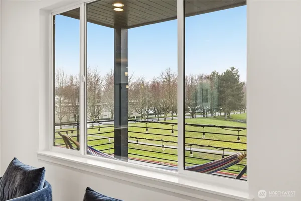 a room with a large window and a bed