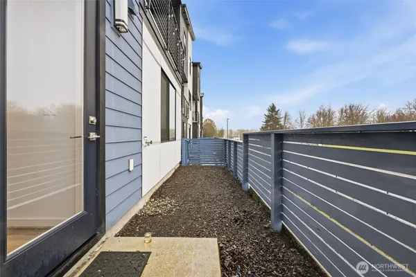 a view of a pathway of a building with wooden floor and fence