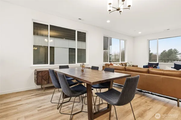 a dining room with a table chairs and wooden floor