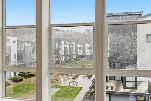 a view of a back yard from a room with a window