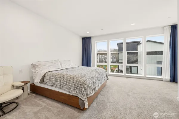 a spacious bedroom with a bed and a large window
