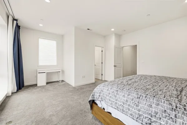 a spacious bedroom with a large bed and closet