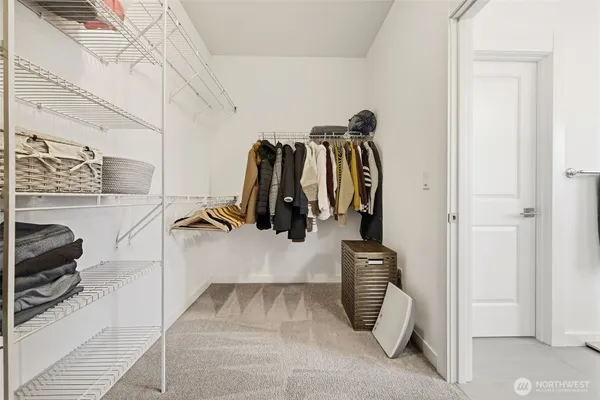 a view of walk in closet with clothes and shoes