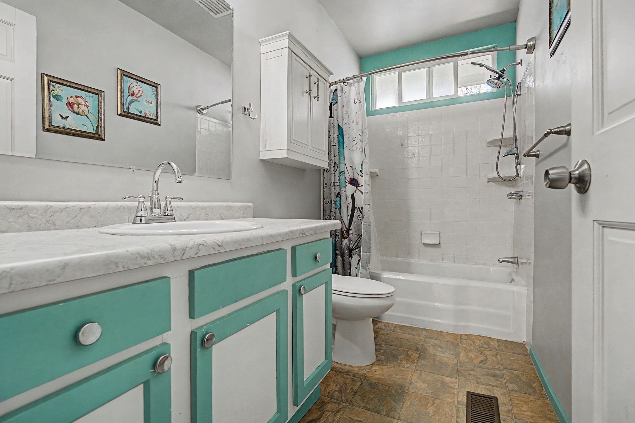 216 4th Street Clifton, CO 81520 - Photo 13 of 17 a bathroom with a granite countertop sink a toilet a mirror and shower
