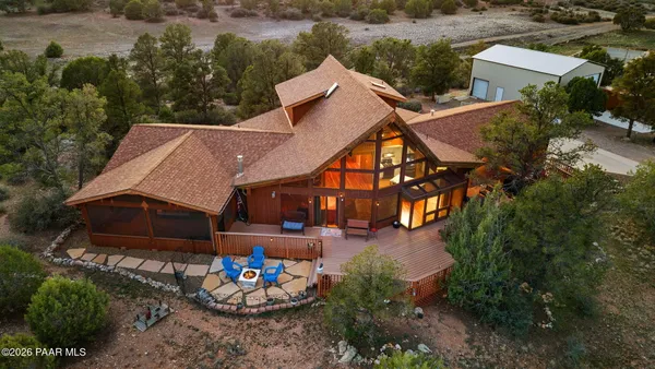 an aerial view of a house with a yard and lake view